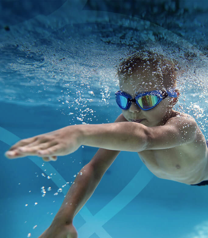 Photo of boy swimming forward: we are working to make a difference for patients with rare endocrine diseases and cancer